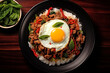 Top view Stir fried minced pork, chili and Thai basil leaves spicy with fried eggs on topped rice, Local food street menu in Thailand