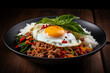 Closeup Stir fried minced pork, chili and Thai basil leaves spicy with fried eggs on topped rice, Local food street menu in Thailand