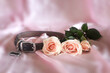 Pink rose beside a leather dog collar in remembrance of a beloved pet.