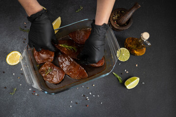 Wall Mural - marinated Pieces of Fresh tuna Fish fillet in glass cooking dish on a kitchen table