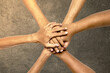 © Leo Lintang - Closeup view of people stacking their hands together for unity and teamwork