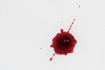 Drops of blood stains on white fabric. blood splatters on clothes. red dripping blood spatters