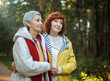 Multiracial old women having a good day in to the wood. Lifestyle and female friendship concept.
