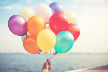 Poster - Person holding a bunch of colorful balloons, perfect for festive occasions