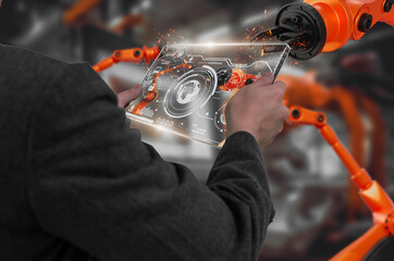 Wall Mural - industry engineer in factory,using smart tablet glass device,control automated robot arm machine lea