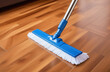 a mop in the process of cleaning. Floor cleaning with mop. blue mop.	