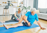 Fototapeta Łazienka - senior active exercise couple training sport fitness home stretching yoga woman man pilates gym together