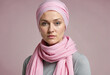 Young woman suffering from cancer with a pink scarf on her head with no hair due to chemotherapy
