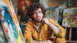 Puzzled thoughtful painter holds palette color samples and paint roller, thinks about modern design, has curly hair, wears yellow jumper, works on architectural project, busy with house repairing
