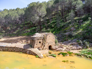 Wall Mural - Aerial drone view of old watermill in the shore of Odiel river in the hiking route of the water mills along the Odiel river from Sotiel Coronada, in Huelva province, Andalusia, Spain