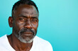 Serious and attractive middle-aged African man in athletic portrait against bright blue backdrop.