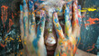 © RISHAD - Person's face hidden behind colorful hands.