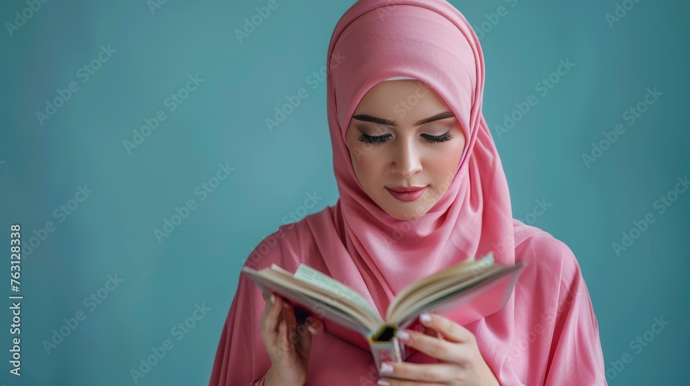 Young muslim woman student in pink hijab holding books on bright blue ...