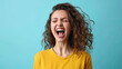 Happy Screaming young woman on pastel blue background.  Joy vibe