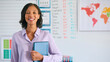 © Monkey Business - Portrait Of Female Primary Or Elementary School Teacher Holding Digital Tablet Standing In Classroom