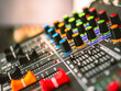 © NARONG - Close-up of sound recording equipment knobs.Mixer control. Music engineer. Backstage controls on an audio mixer, Sound mixer. Professional audio mixing console, buttons, faders and sliders.