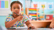 © Monkey Business - Female Primary Or Elementary School Student At Desk In Classroom