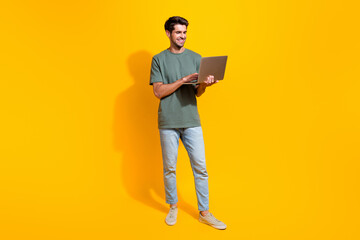 Aufkleber - Full length photo of confident positive man dressed khaki t-shirt chatting twitter telegram facebook isolated yellow color background