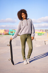 Wall Mural - Portrait, smile and woman with skateboard on street in city in summer for sport, health and exercise outdoor. Happy person, skate park and gen z girl in casual clothes for fashion in South Africa