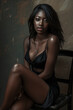 © larrui - A woman in a black dress sits on a chair. She has a beautiful, sensual look on her face