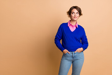 Sticker - Photo portrait of attractive young woman hands pockets look empty space promo wear trendy blue clothes isolated on beige color background