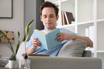 Poster - Male student reading book at home