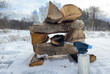 Burning bonfire in frost winter. Campfire in nature, made of dry firewood on white snow. Lighting firewood using gas burner in winter. Lighting a Fire in frost on snow. Hardwood Logs for bonfire