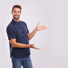 Wall Mural - Happy man, studio and portrait with pointing to mockup and hand gesture for sign or advertising. Model, face and positive for show to choice or copy space, information and branding by grey background