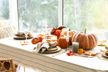 Canvas Print - Autumn setting with pumpkins on dining table in room