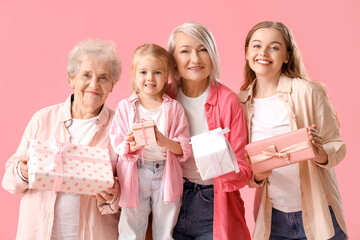 Wall Mural - Little girl with her family and gifts on pink background