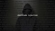 Cyber attack shellcode injection text in foreground screen, anonymous hacker hidden with hoodie in the blurred background. Vulnerability text in binary system code on editor program.