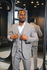 Wall Mural - Young african man shopping in clothing store