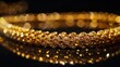 An intimate look at yellow gold jewelry, presented in a close-up view against a black background, emphasizing its allure 