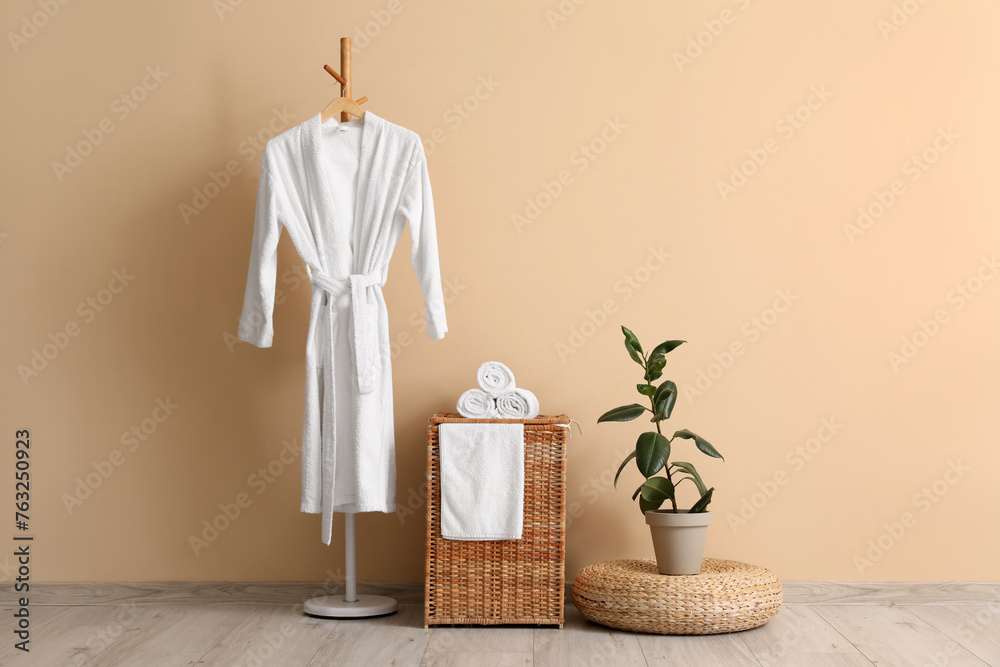 Interior of room with laundry basket, bathrobe and pouf