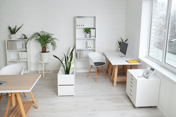 Canvas Print - Interior of office with table, shelf units and plants