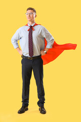 Poster - Funny businessman with superhero cape on yellow background