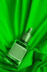 Wall Mural - Beauty bottle on green fabric