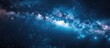 The milky way galaxy can be seen in the night sky, resembling a flowing river of stars against the darkness, like an underwater landscape of electric blue clouds