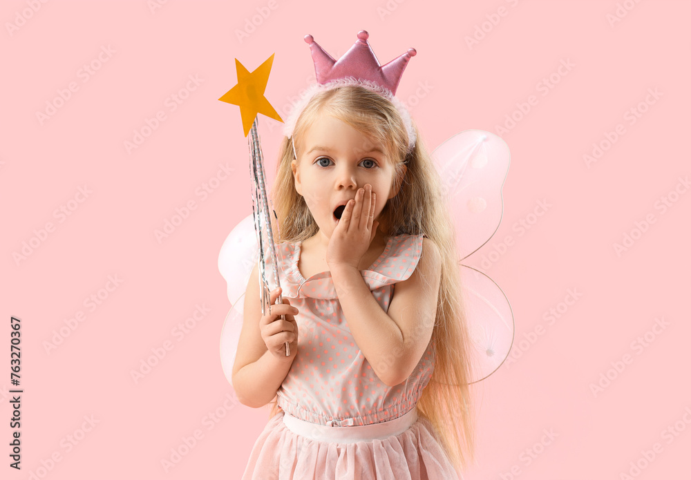 Shocked little fairy on pink background
