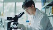 Researcher asian man wear lab cost work mixing test tube specialist sample chemist equipment with microscope at laboratory. Student young boy examining biotechnology health medical.