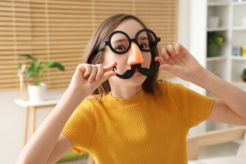 Poster - Funny little girl in disguise at home, closeup. April Fools' Day celebration