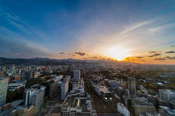 Wall Mural - sunset or sun rise of Sapporo cityscape with Skyline and office building and downtown of sappiro is  populars ciy from toursim Hokkaido, Japan with twilight sky in spring season