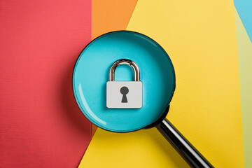 Wall Mural - A magnifier glass focuses on a padlock icon