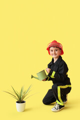 Sticker - Cute little firefighter watering plant on yellow background