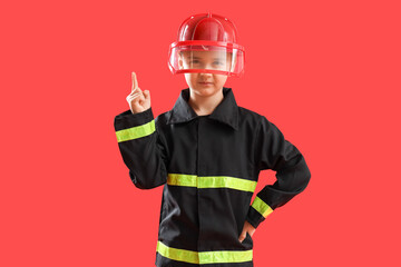 Sticker - Cute little firefighter pointing at something on red background