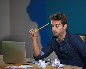 Poster - Crumpled, paper and man at laptop thinking for creative ideas, online research and brain fog in office. Brainstorming, computer and frustrated designer at desk with professional career at startup