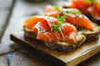 Close-up of smoked salmon on open-faced sandwiches, ideal for culinary themes.