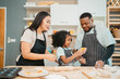 © chokniti - happy child family with father or mother cooking fun together for bakery bread meal in kitchen, young African little kid daughter girl and parent in love childhood lifestyle at home for food homemade