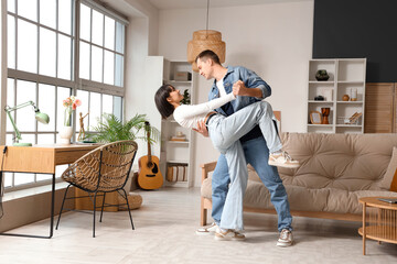 Wall Mural - Young couple in love dancing at home
