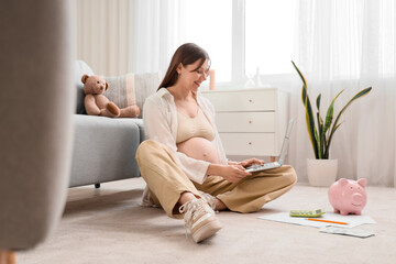 Sticker - Young pregnant woman using laptop at home. Maternal Benefit concept